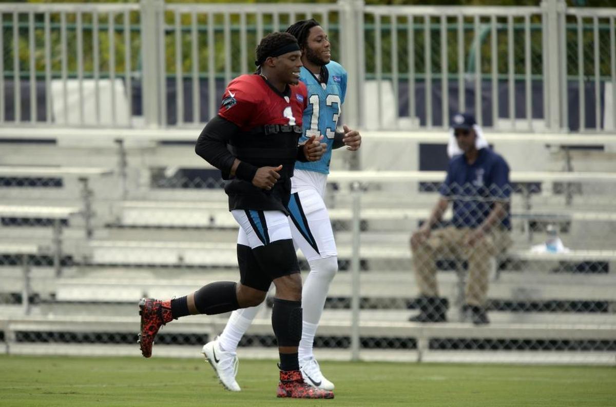 Cam Newton (in red jersey) and Kelvin Benjamin are close friends and sometimes jog together after practice, as they did here in August. On Sunday, Newton said that Benjamin was the type of player you would want in a “foxhole” with you. On Tuesday, Benjamin was traded.