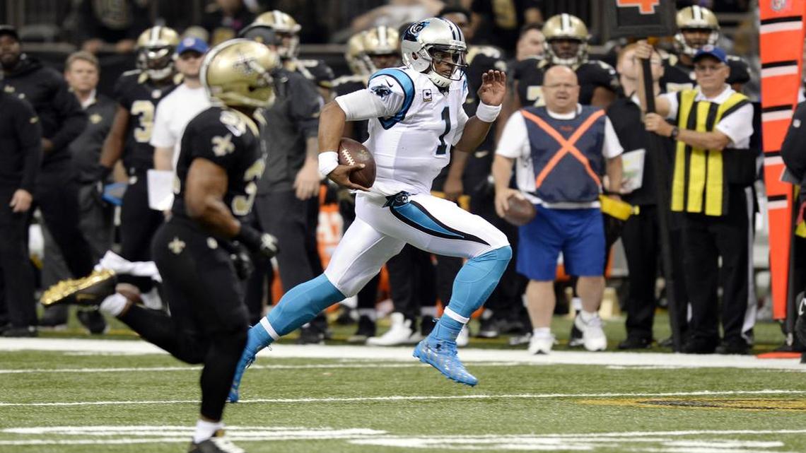 Carolina Panthers' Cam Newton (1) runs for a first down against the New Orleans Saints in the first half at the Mercedes-Benz Superdome on Sunday, December 6, 2015. The Panthers won 41-38, and improve to 12-0.