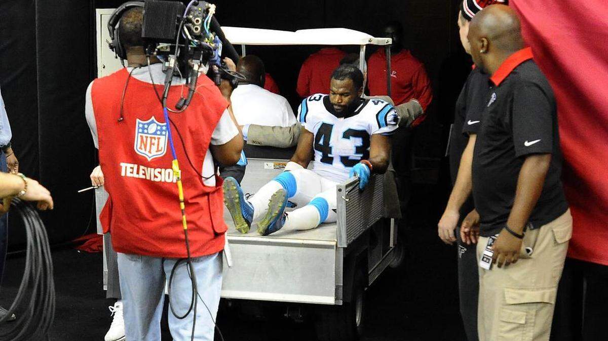 Carolina Panthers running back Fozzy Whittaker (43) is carted off the field in the second half during the game against the Atlanta Falcons at the Georgia Dome on Sunday.