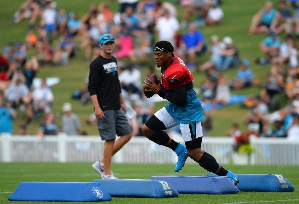 Carolina Panthers coach Ron Rivera said he was not concerned by quarterback Cam Newton’s arm fatigue Sunday. Above, Newton jumps over pads as he runs through a passing drill during Friday’s practice in Spartanburg.
