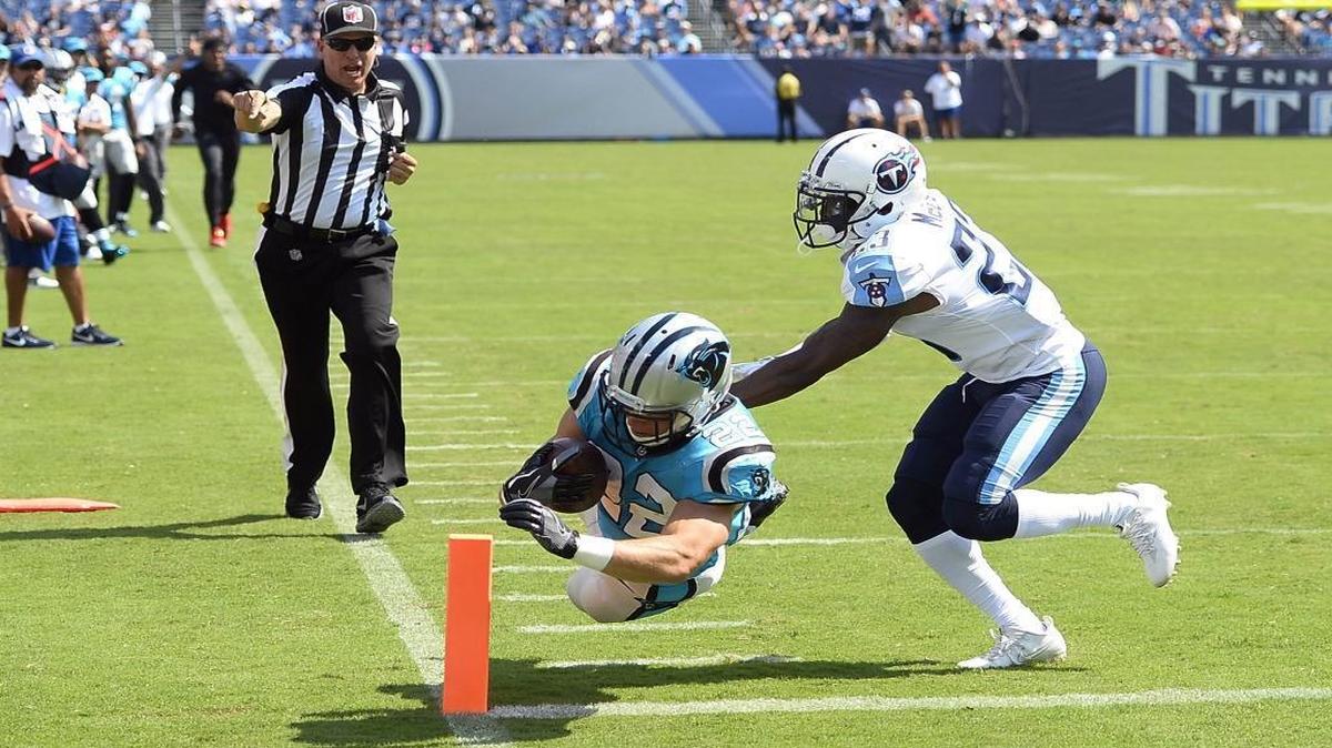 Carolina Panthers rookie running back Christian McCaffrey (22) dives for the pylon to score his first-ever NFL touchdown as Tennessee Titans cornerback Brice McCain (23) pursues him in Saturday’s game against the Tennesee Titans in Nashville.