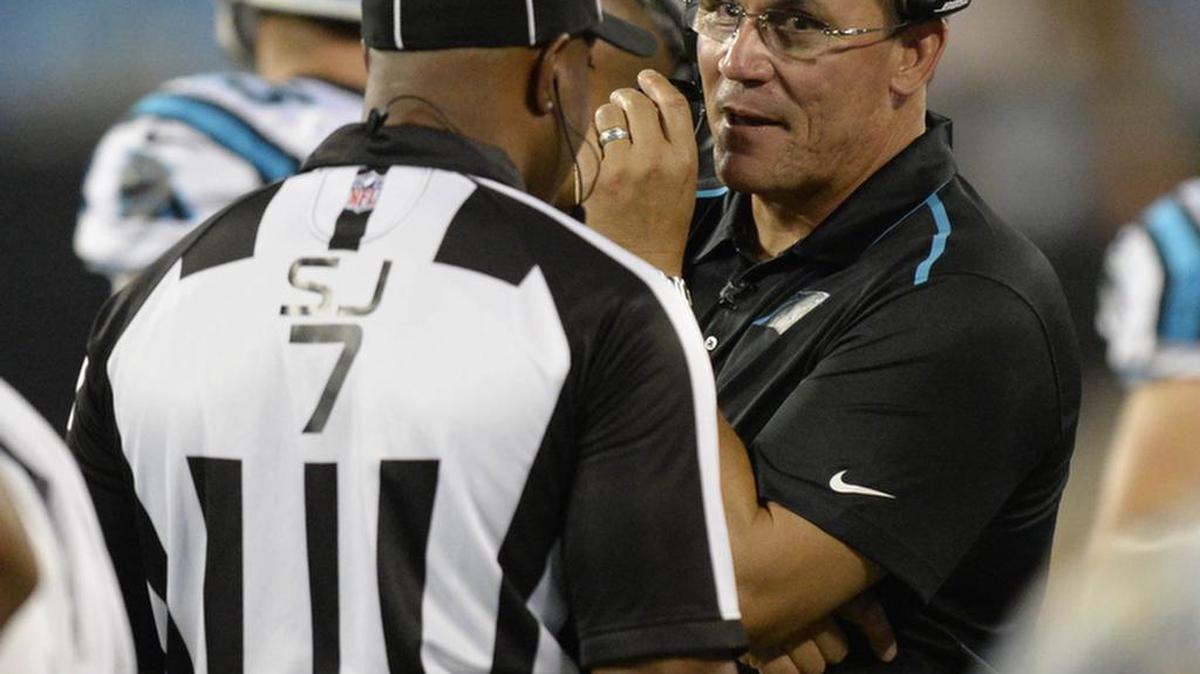 
Carolina Panthers head coach Ron Rivera talks with side judge Keith Washington (7) during the second half against the Miami Dolphins during their preseason game at Bank of America Stadium on Saturday, August 22, 2015. The Panthers won, 31-30.
