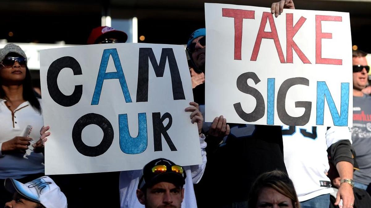 Carolina Panthers fans request quarterback Cam Newton to take their signs during Sunday’s game at Nissan Stadium in Nashville. The Panthers defeated the Tennessee Titans, 27-10.