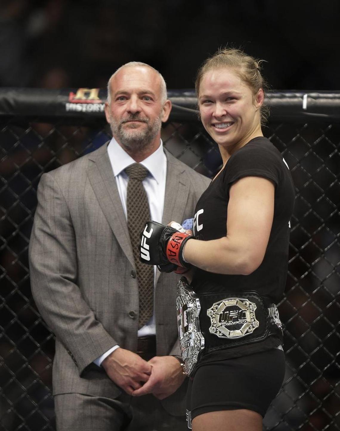 Ronda Rousey, right, smiles with UFC owner Lorenzo Fertitta on Saturday, Feb. 22, 2014, in Las Vegas. Sources say Fertitta and his brother, Frank, have been cited as possible bidders for the Carolina Panthers.