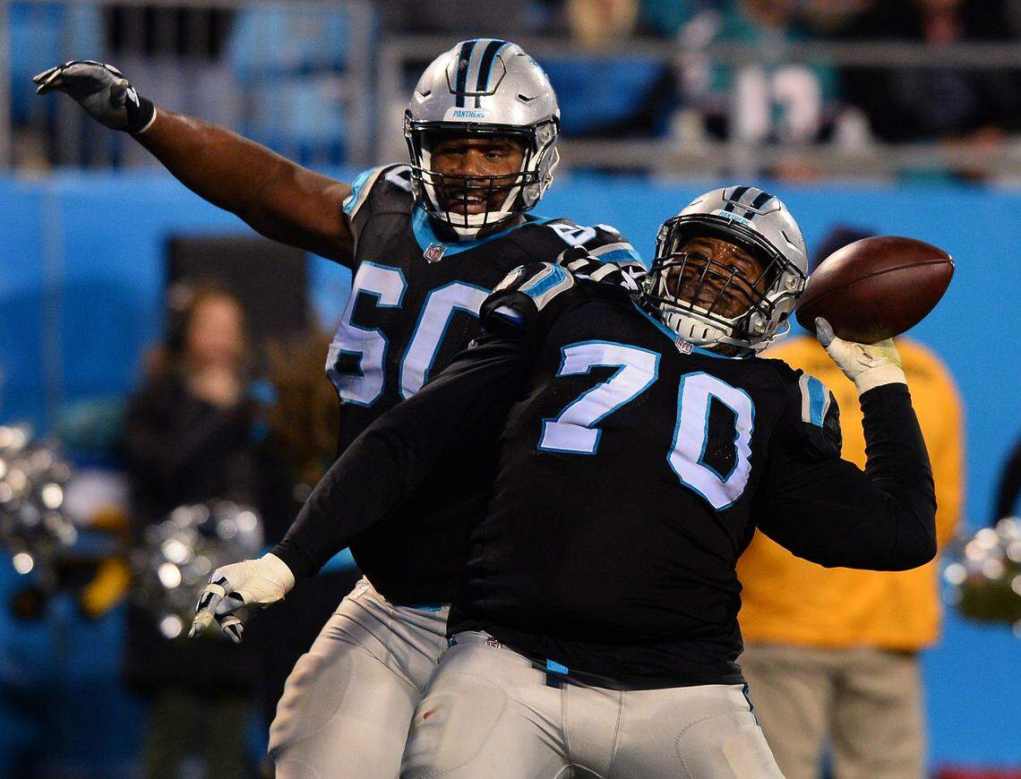 Carolina Panthers guard Trai Turner throws the football that running back Christian McCaffrey scored a touchdown with into the crowd as the team celebrates against the Miami Dolphins during third quarter action on Monday, November 12, 2017 at Bank of America Stadium in Charlotte, NC.
