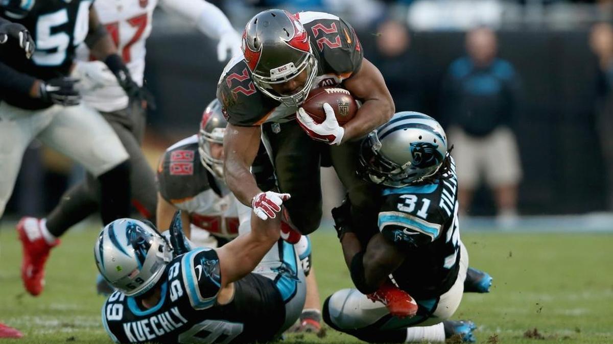 Carolina Panthers cornerback Charles Tillman (31) helps make a tackle on Doug Martin (22) of the Tampa Bay Buccaneers on Sunday. Tillman later tore the ACL in his right knee on a non-contact play.