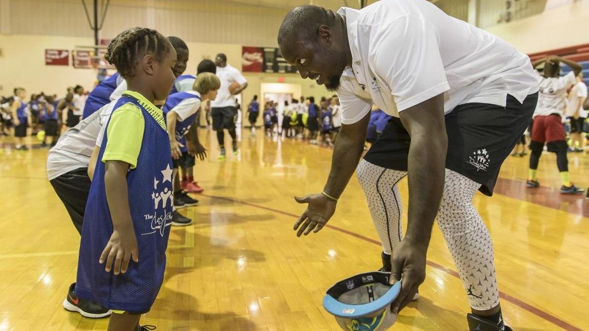 
Carolina Panthers defensive end Charles Johnson works at a basketball camp during the 4th Annual Charles Johnson Foundation Sports Academy in Hawkinsville, Ga., in June. 
