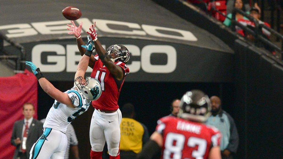 Atlanta Falcons wide receiver Julio Jones leaps over Carolina Panthers linebacker Luke Kuechly for a deep pass reception from quarterback Matt Ryan during third quarter action at the Georgia Dome on Sunday, December 27, 2015 in Atlanta, GA. Jones pass reception resulted into a touchdown run following the catch. The Falcons defeated the Panthers 20-13.