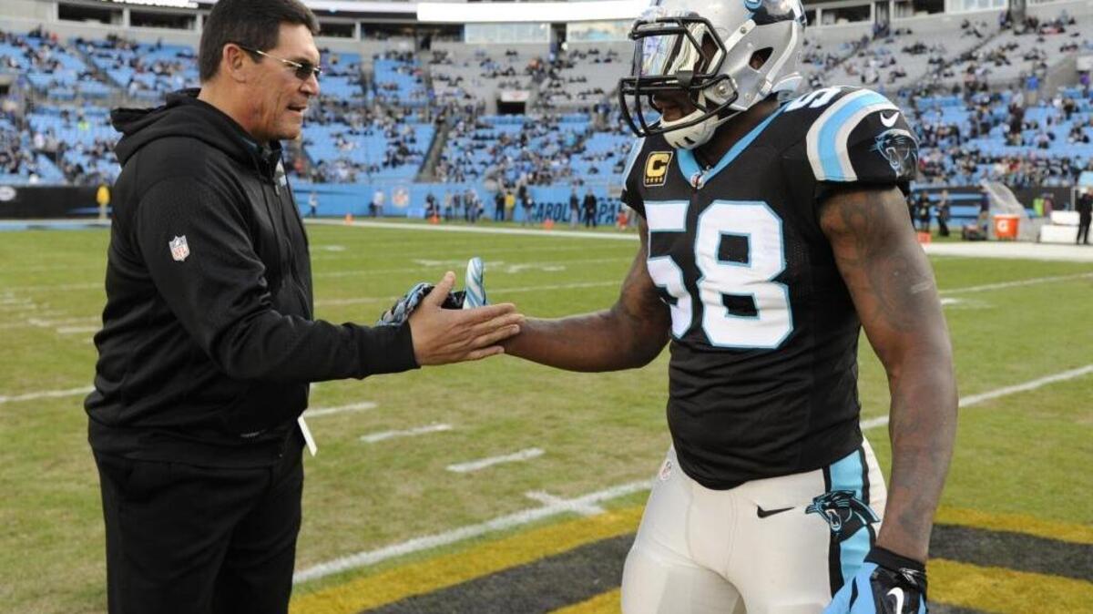 Carolina Panthers head coach Ron Rivera, left, and outside linebacker Thomas Davis (58) are usually on the same page – but not about the meaning of the team’s 15-1 finish this season.