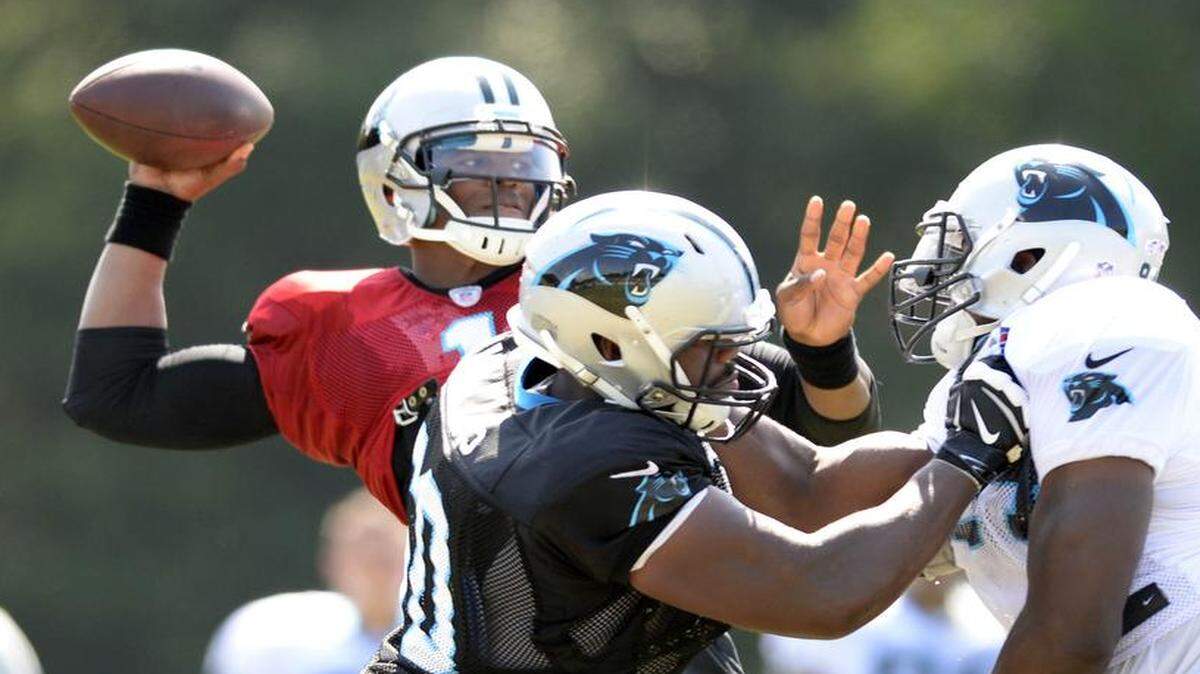 
Carolina Panthers quarerback Cam Newton (1) gets blocking from Daryl Williams (60) during morning practice at at Wofford College in Spartanburg on Tuesday. Williams, a rookie out of Oklahoma, has worked at both offensive tackle slots but says he is more comfortable on the right side.
