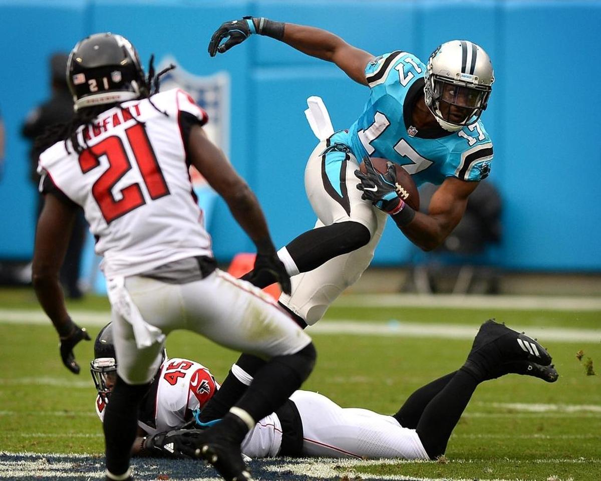 Carolina Panthers wide receiver Devin Funchess, right, steps over Atlanta Falcons linebacker Deion Jones in the third quarter. Funchess was the Panthers’ leading receiver.