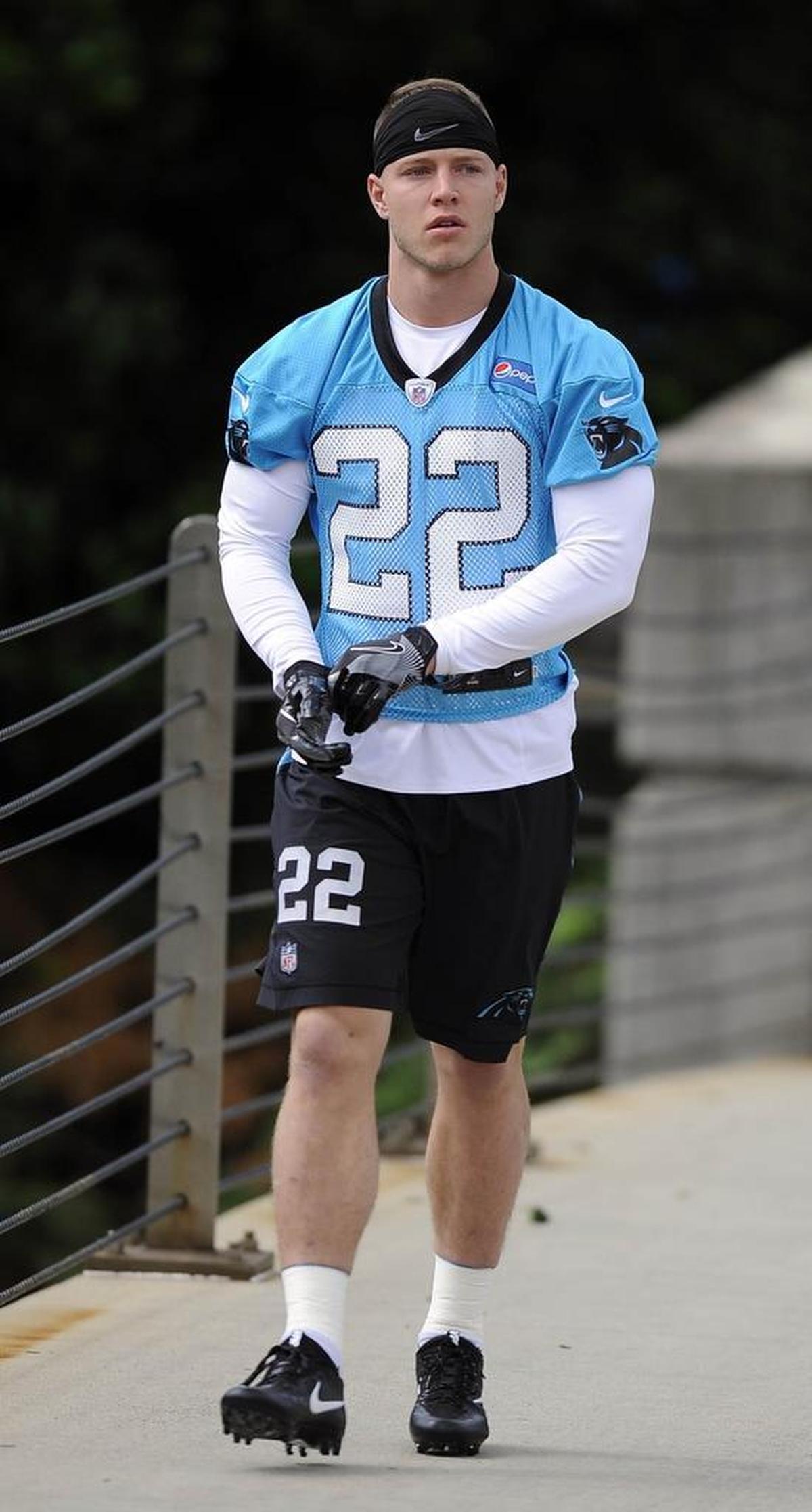 Carolina Panthers running back Christian McCaffrey walks to the field for the first session of the team’s rookie camp on Friday.