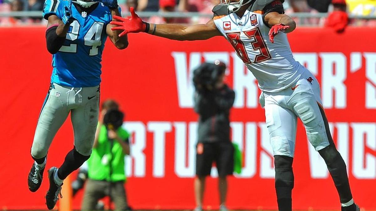 Josh Norman intercepts a pass by Tampa Bay QB Jameis Winston meant for Vincent Jackson, right.
