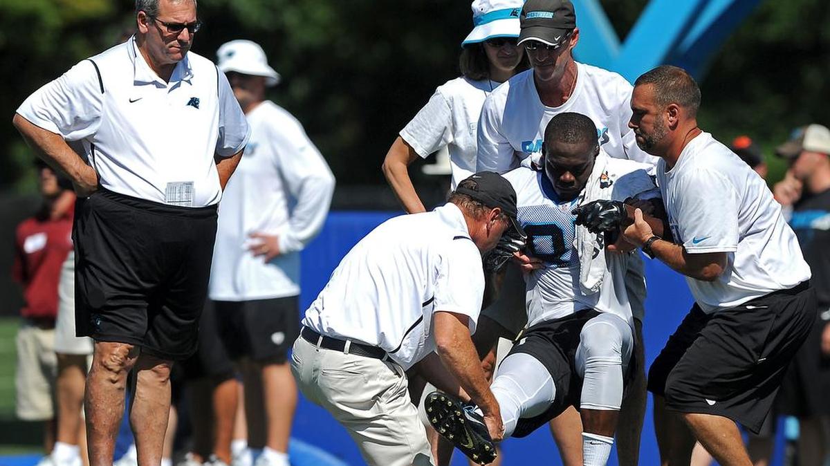
Carolina Panthers personnel help wide receiver Stephen Hill, center, to a cart after he was injured during practice at Wofford College in Spartanburg, S.C., on Saturday, Aug. 1, 2015. At left, Panthers general manager Dave Gettleman looks on.
