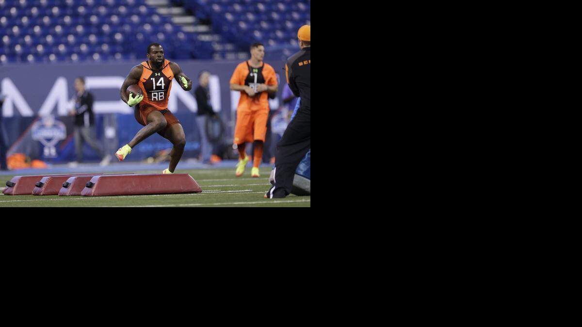
Ball State running back Jahwan Edwards, who went to Charlotte’s Butler High, runs a drill at the NFL football scouting combine in Indianapolis on Saturday. Edwards has gone from only one college scholarship offer to competing with the best draftable running backs in the country at the combine.
