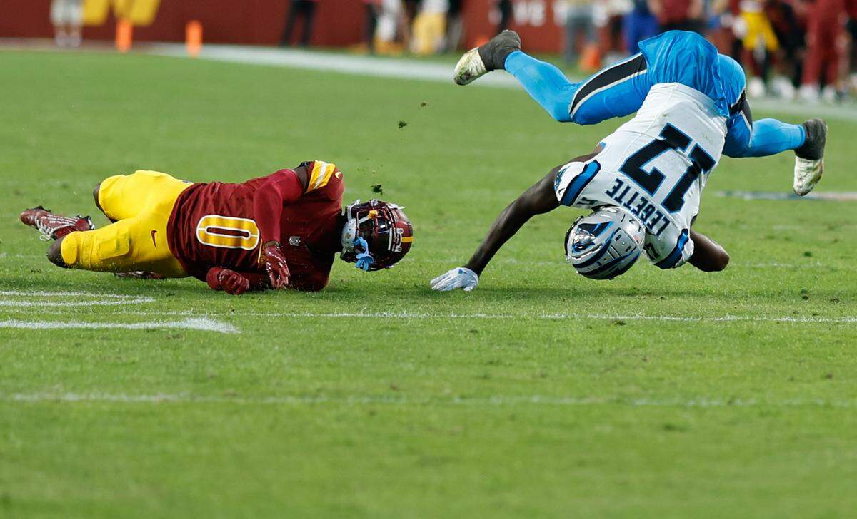 Oct 20, 2024; Landover, Maryland, USA; Carolina Panthers wide receiver Xavier Legette (17) is tackled by Washington Commanders cornerback Mike Sainristil (0) during the fourth quarter at Northwest Stadium. Mandatory Credit: Geoff Burke-Imagn Images
