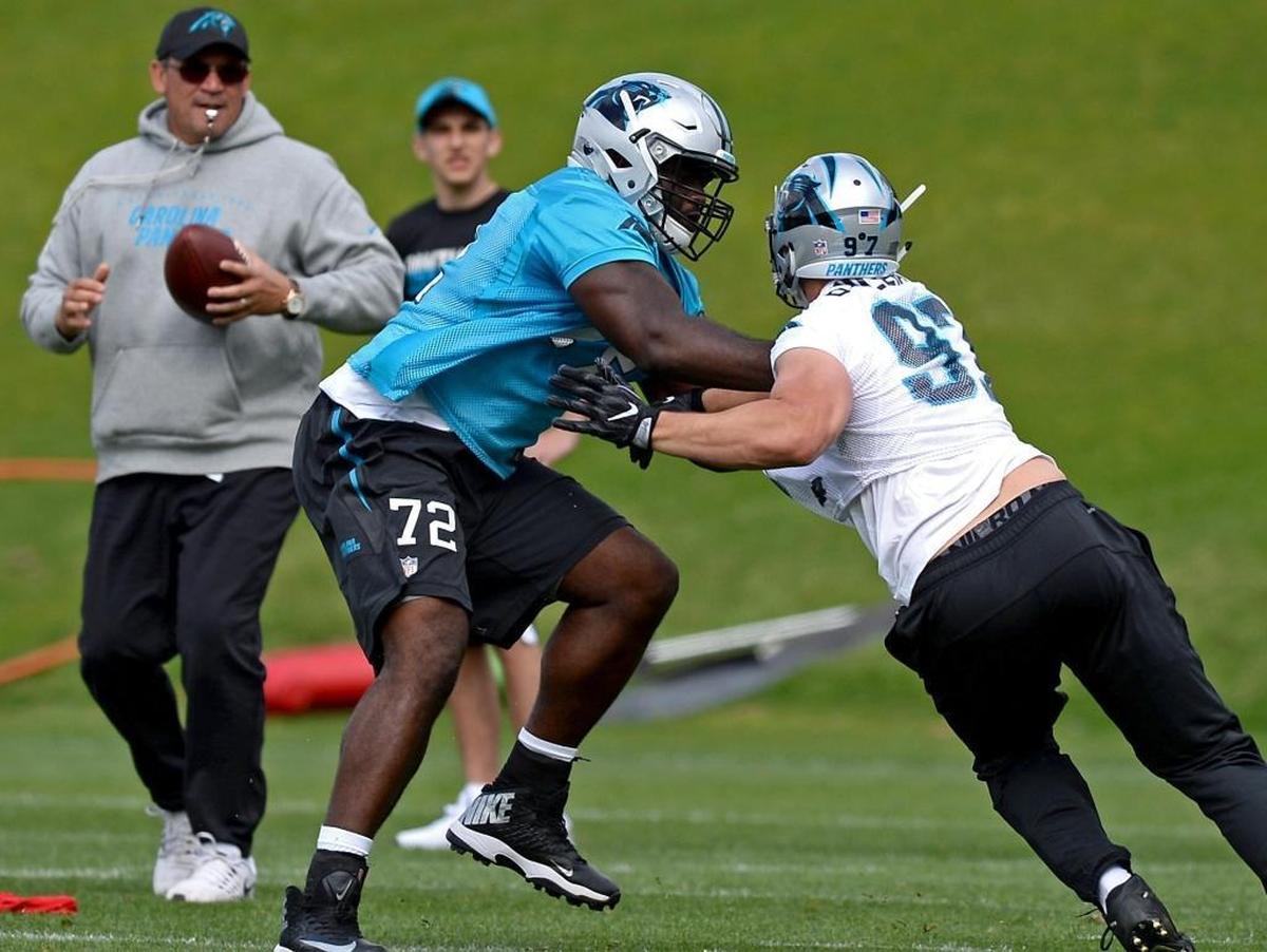 Carolina Panthers rookie tackle Taylor Moton, center/left, battles defensive end Brandon Williams, right, during the team's second session practice of the rookie minicamp on Friday, May 5, 2017. Looking on is head coach Ron Rivera, left.