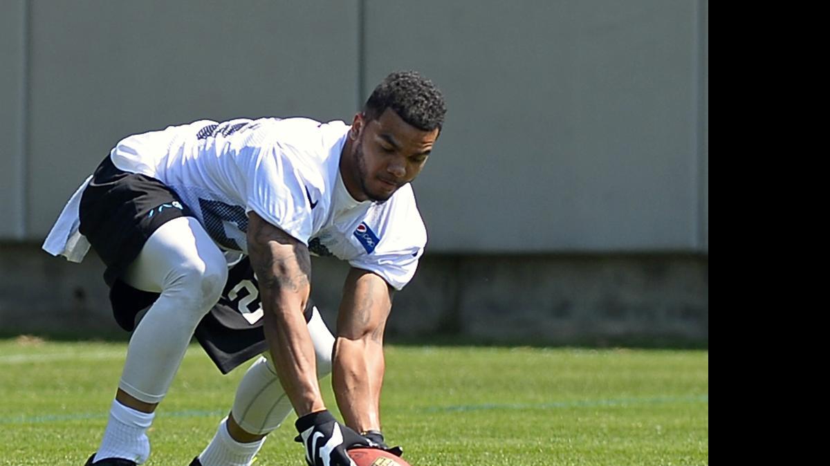 
Carolina Panthers safety Dean Marlowe reaches down to retrieve a football during the team's rookie minicamp on Friday, May 8, 2015.
