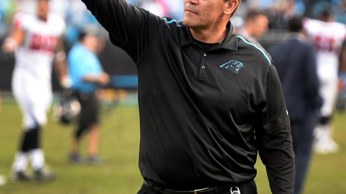 Carolina Panthers head coach Ron Rivera points toward the stands as he exits the field following the team's victory over the Atlanta Falcons on Sunday, December 13, 2015. The Panthers defeated the Falcons 38-0. Some Charlotte fans say Rivera’s Latin American heritage has encouraged new fans to follow the sport.