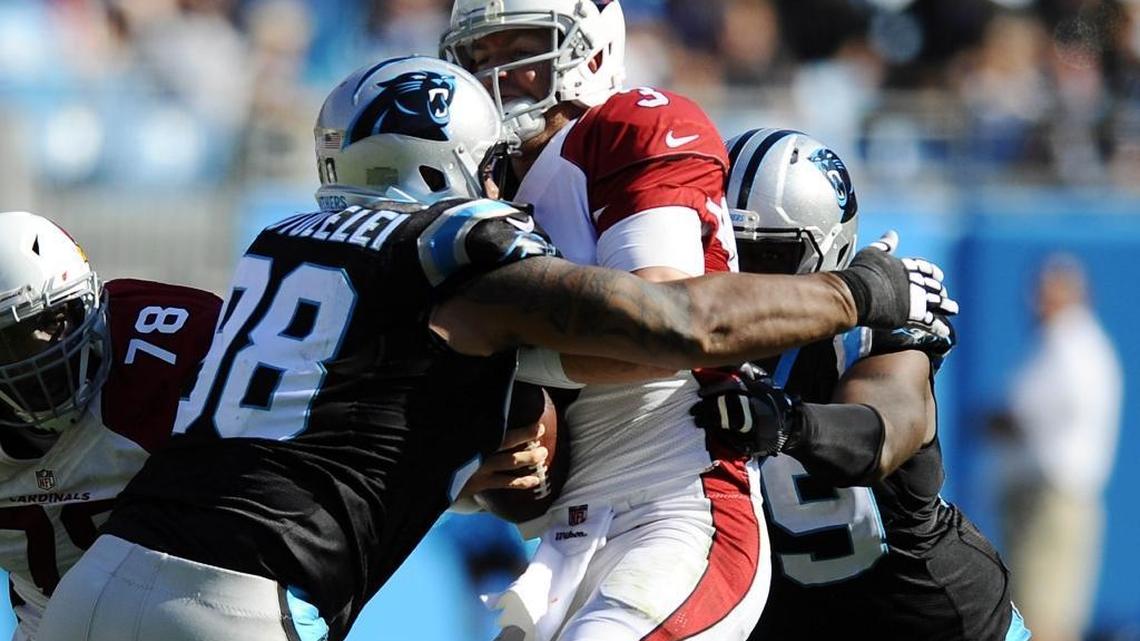 Arizona Cardinals quarterback Carson Palmer gets sacked by Carolina Panthers defensive tackle Star Lotulelei (98) and defensive tackle Kawann Short (99) during the first half of Sunday’s game. The Panthers defeated the Cardinals 30-20.
