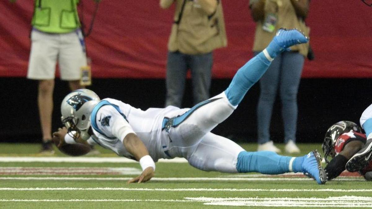 Carolina Panthers quarterback Cam Newton stretches to score a 2-point conversion after being hit by Atlanta Falcons outside linebacker Deion Jones on Sunday.