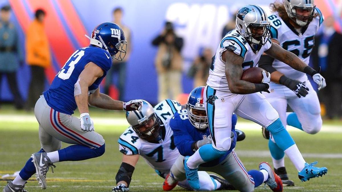 Carolina Panthers running back Cameron Artis-Payne fights for yardage vs the New York Giants defense during second quarter action at MetLife Stadium in East Rutherford, NJ on Sunday, December 20, 2015. The Panthers defeated the Giants 38-35.