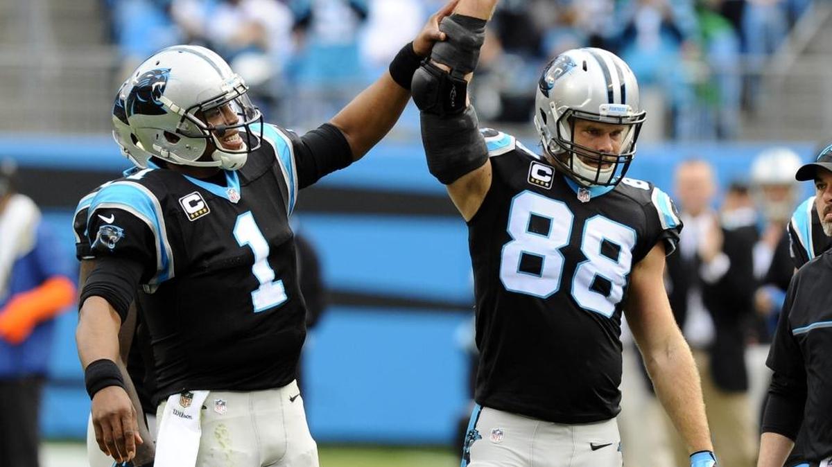 Carolina Panthers quarterback Cam Newton (1) lifts tight end Greg Olsen (88) arm in celebration after Olsen's record breaking reception in the second quarter against the Atlanta Falcons at Bank of America Stadium on Saturday, December 24, 2016. The reception made Olsen the first tight end in NFL history to have 3 consecutive seasons with 1,000 yards.