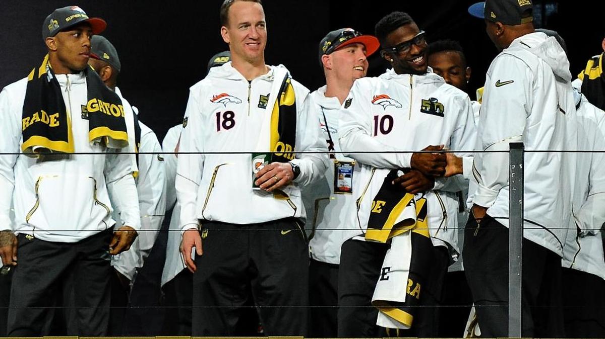 Denver Broncos quarterback Peyton Manning smiles as he stands with his teammates during the Super Bowl Opening Night at SAP Center in San Jose, CA. The Denver Broncos will face the Carolina Panthers in Super Bowl 50 on Sunday, February 7, 2016 in Santa Clara, CA.