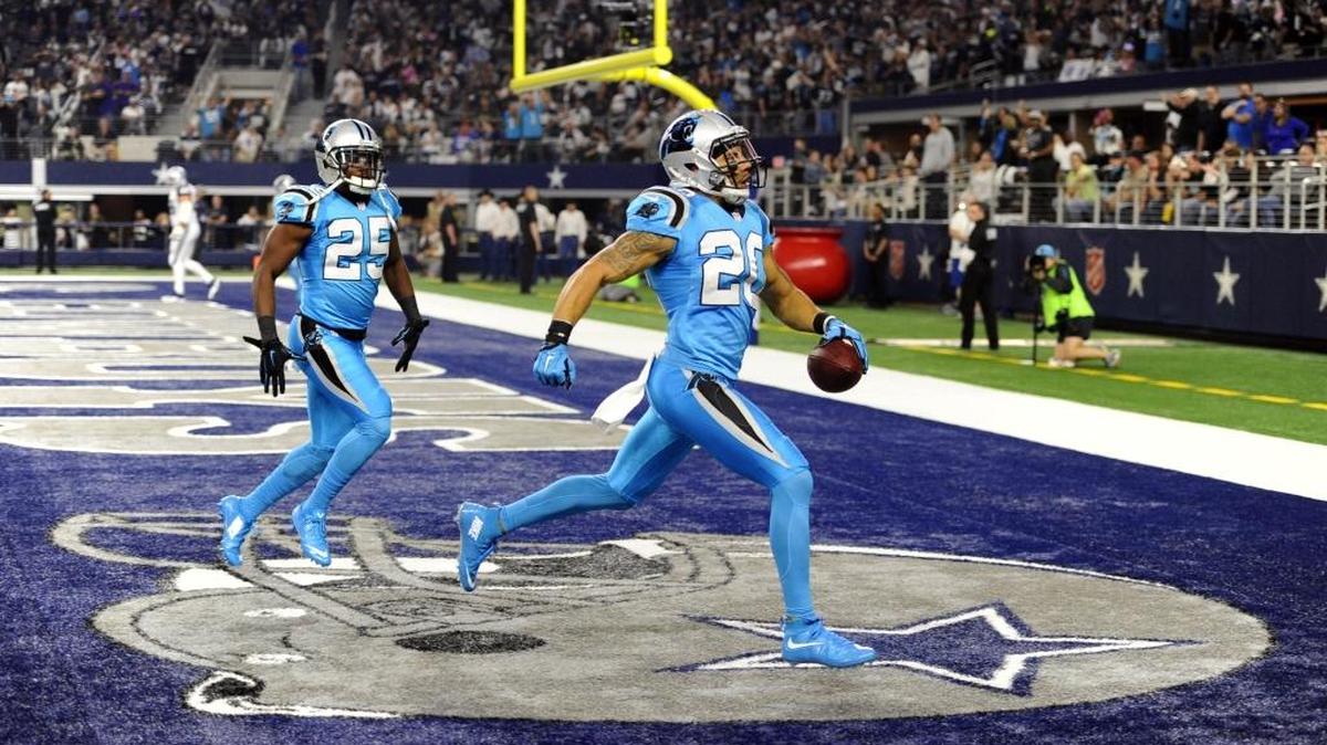 Carolina Panthers safety Kurt Coleman (20) scores a touchdown after intercepting a Dallas Cowboys' Tony Romo (9) pass in the first quarter at AT&T Stadium on Thursday.