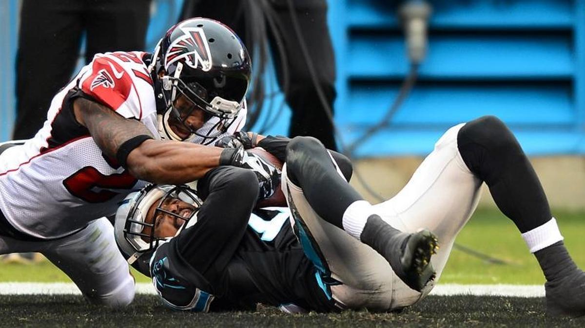 Carolina Panthers wide receiver Philly Brown (16) falls into the end zone with a touchdown pass reception during fourth quarter action as Atlanta Falcons cornerback Robert McClain (27) tries to strip the ball away on Sunday, November 16, 2014 at Bank of America Stadium in Charlotte. McClain was signed by the Panthers Tuesday.