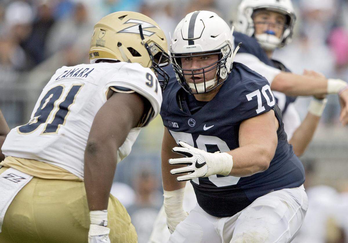 Penn State offensive lineman Brendan Mahon blocks Akron defensive lineman Ibrahima Camara as Trace McSorley makes a pass during the Saturday, September 2, 2017 game at Beaver Stadium.  Penn State won, 52-0.