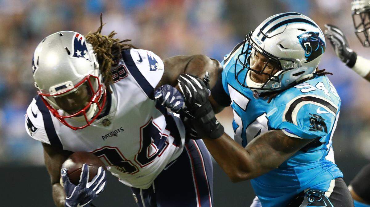 Carolina Panthers’ Shaq Green-Thompson (54) hits New England Patriots’ Cordarrelle Patterson (84) during the first half of a preseason NFL football game in Charlotte, N.C., Friday, Aug. 24, 2018. (AP Photo/Jason E. Miczek)