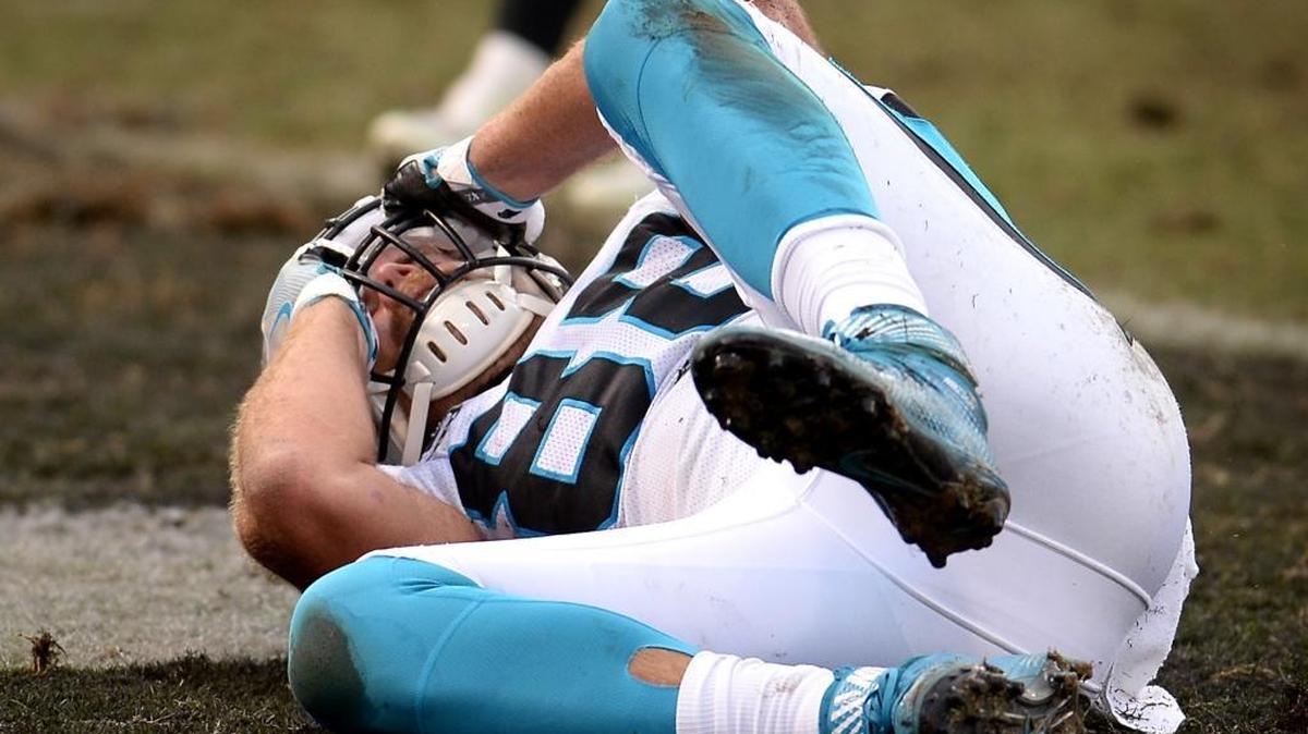 Carolina Panthers tight end Greg Olsen grabs his face mask after he was unable to catch a two-point attempt from quarterback Cam Newton during the third quarter on Sunday.