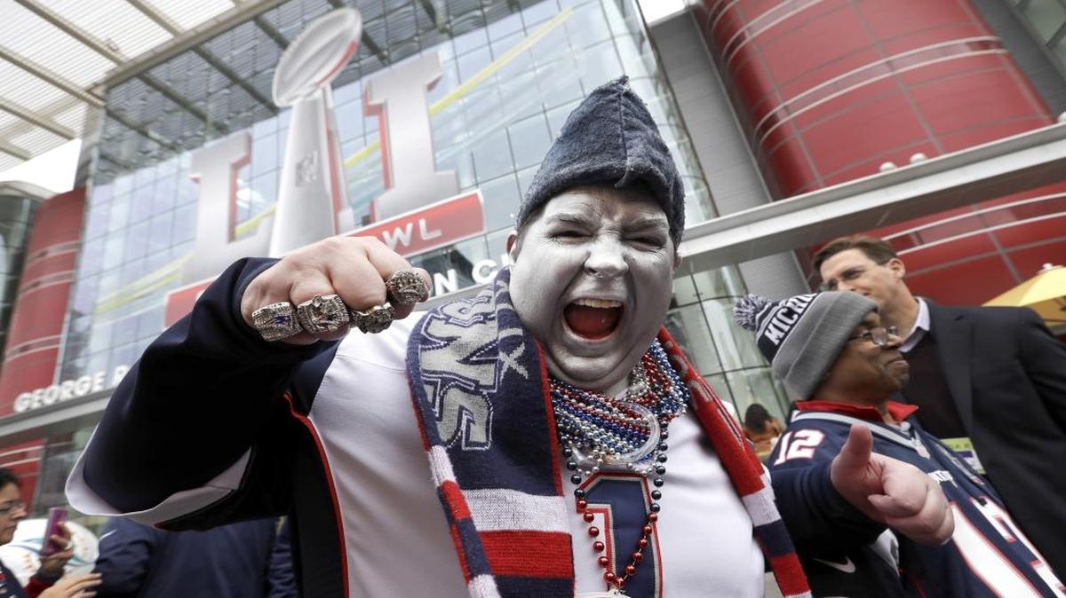New England Patriots fan Keith Birchall cheers for his team outside the NFL Experience for the NFL Super Bowl 51 football game Friday in Houston.