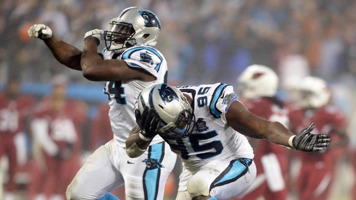 
Carolina Panthers' Kony Ealy (94) and Charles Johnson (95) celebrate a sack against the Arizona Cardinals in the second half of their Wild Card NFL playoff game at Bank of America Stadium on January 3, 2015. 
