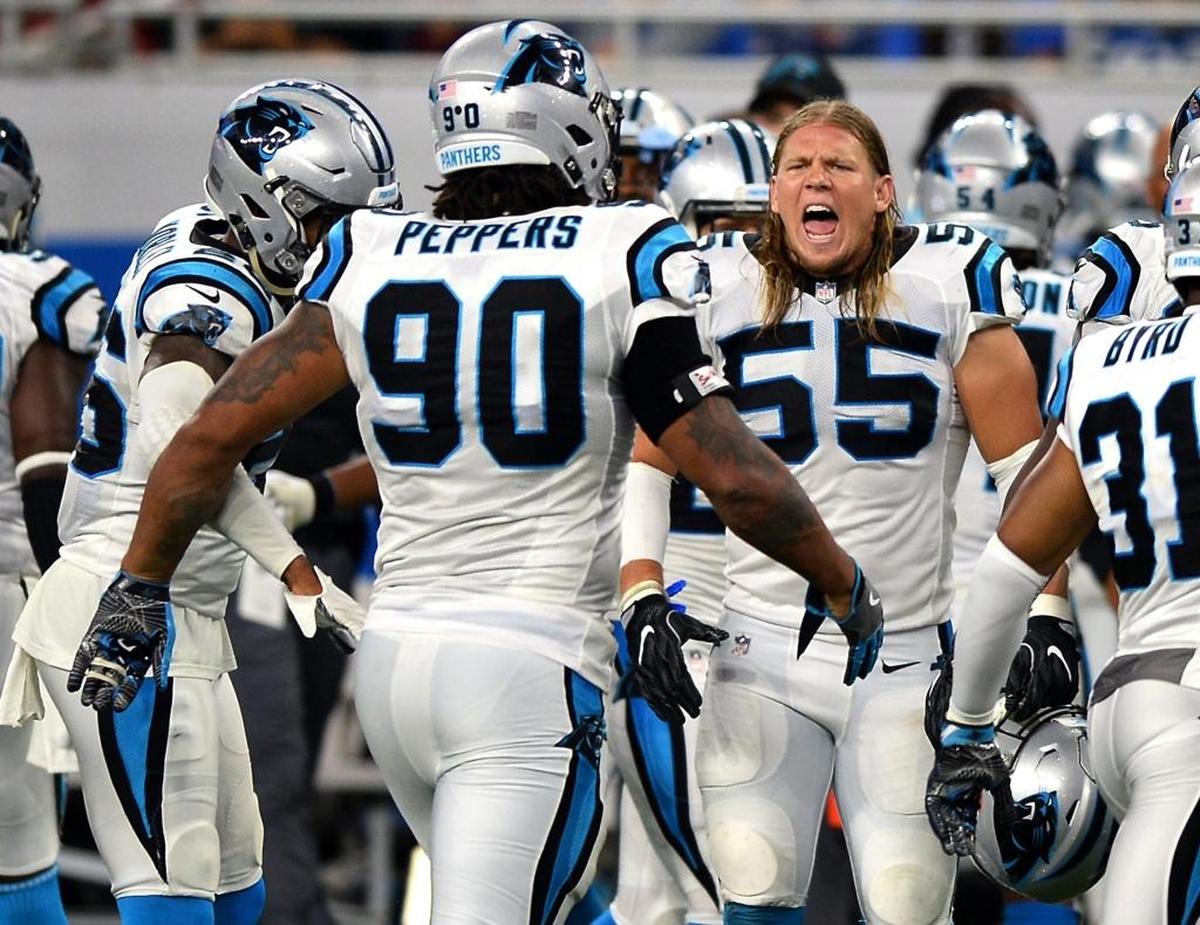 Carolina Panthers linebacker David Mayo (55) congratulates Julius Peppers (90) after Peppers made a fourth-down tackle on Detroit running back Zach Zenner.