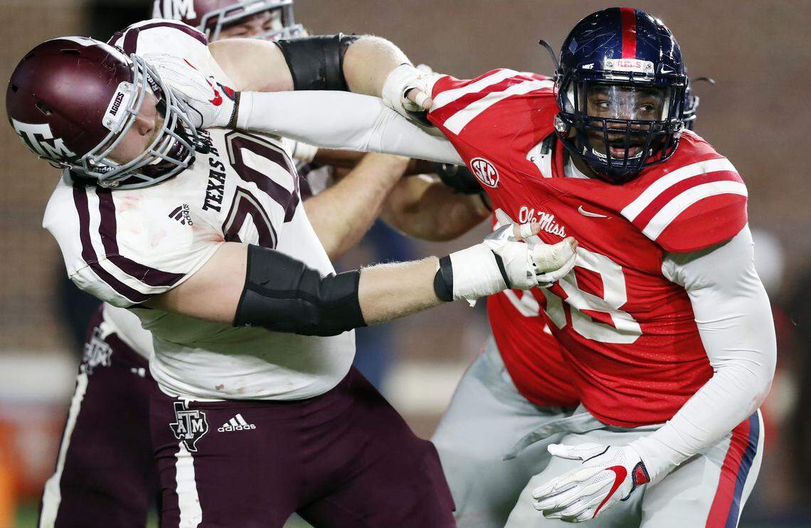 Texas A&M offensive lineman Connor Lanfear (70) holds up Mississippi defensive end Marquis Haynes (38) during the second half of an NCAA college football game in Oxford, Miss., Saturday, Nov. 18, 2017. Texas A&M won 31-24. (AP Photo/Rogelio V. Solis)