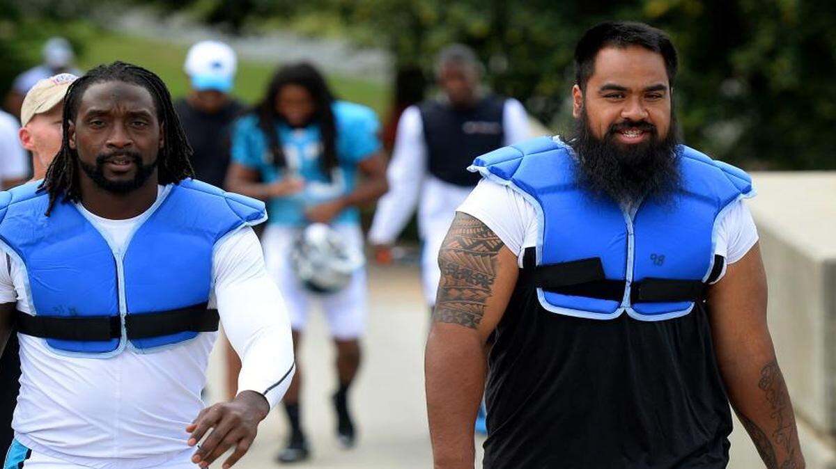 
Carolina Panthers defensive tackle Star Lotulelei, right, walks to practice with cornerback Charles Tillman on Wednesday.
