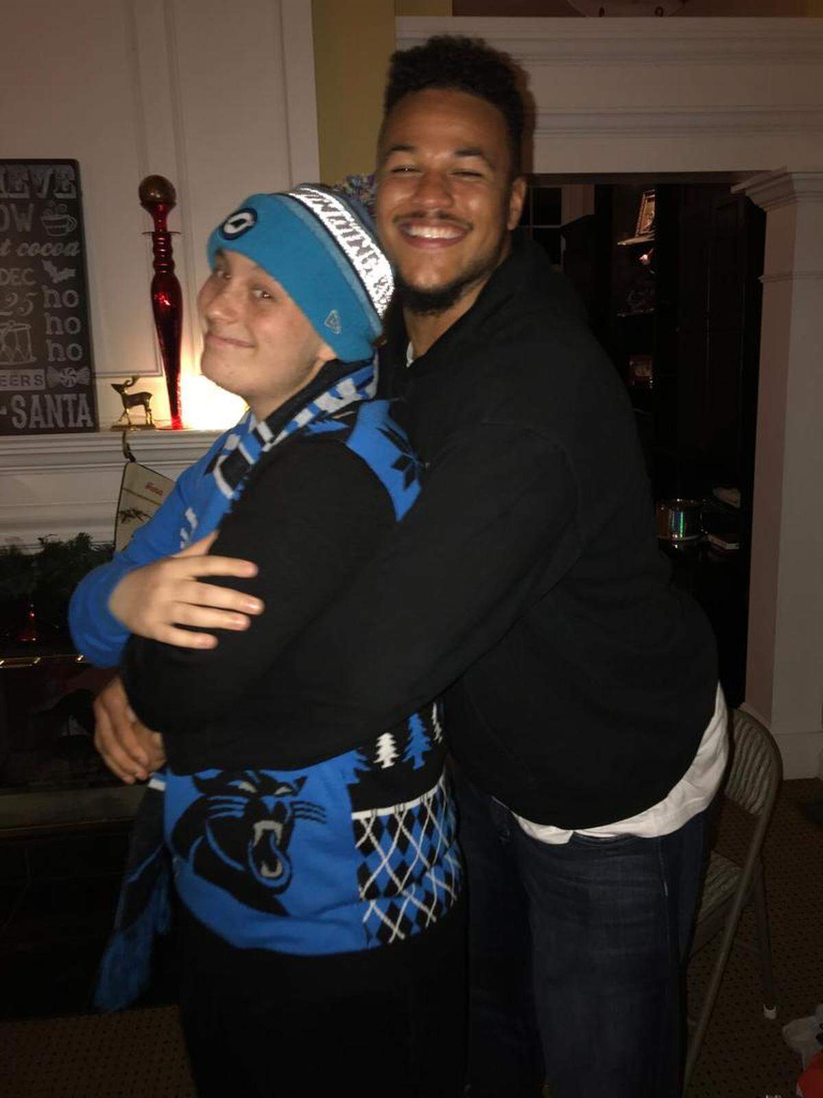 Noah Hays, left, and Carolina Panthers defensive end Wes Horton take a goofy photo at Christmas.