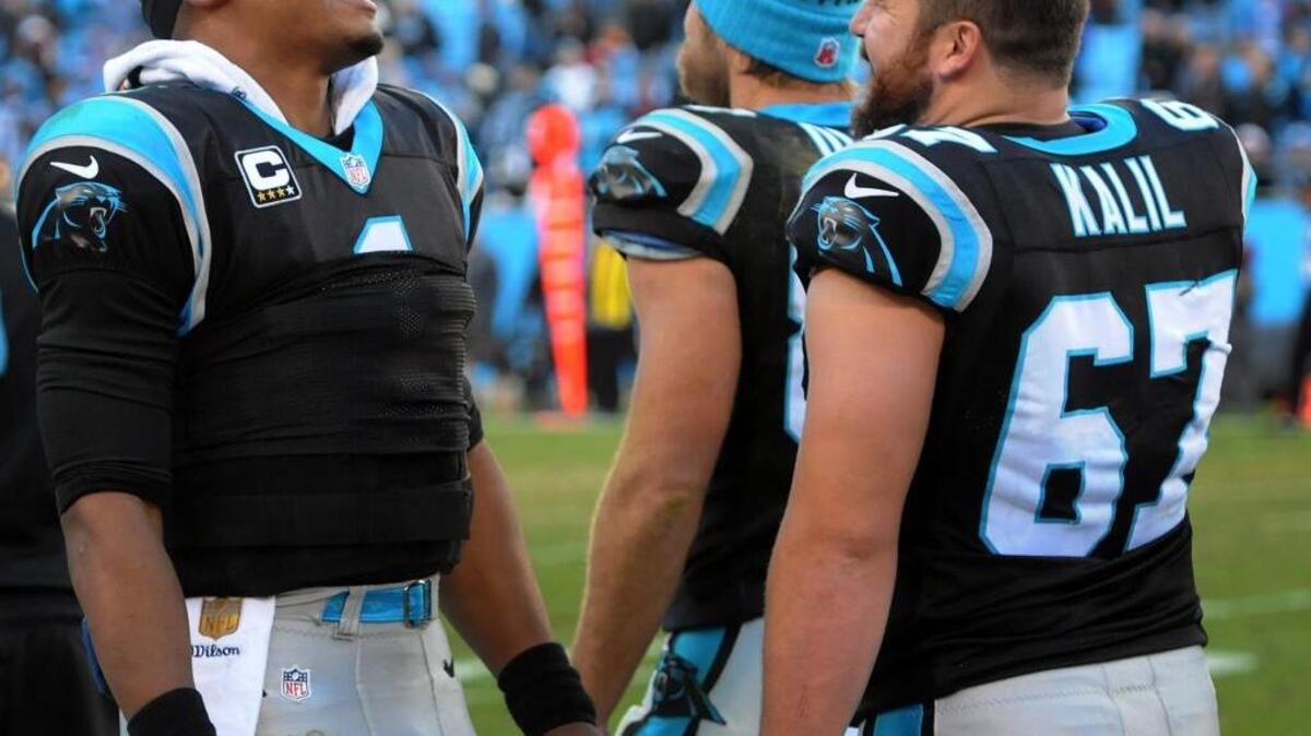 Carolina Panthers quarterback Cam Newton, left, and center Ryan Kalil, right, talk in the bench area during fourth quarter action vs Washington at Bank of America Stadium in Charlotte, NC on Sunday, November 22, 2015.