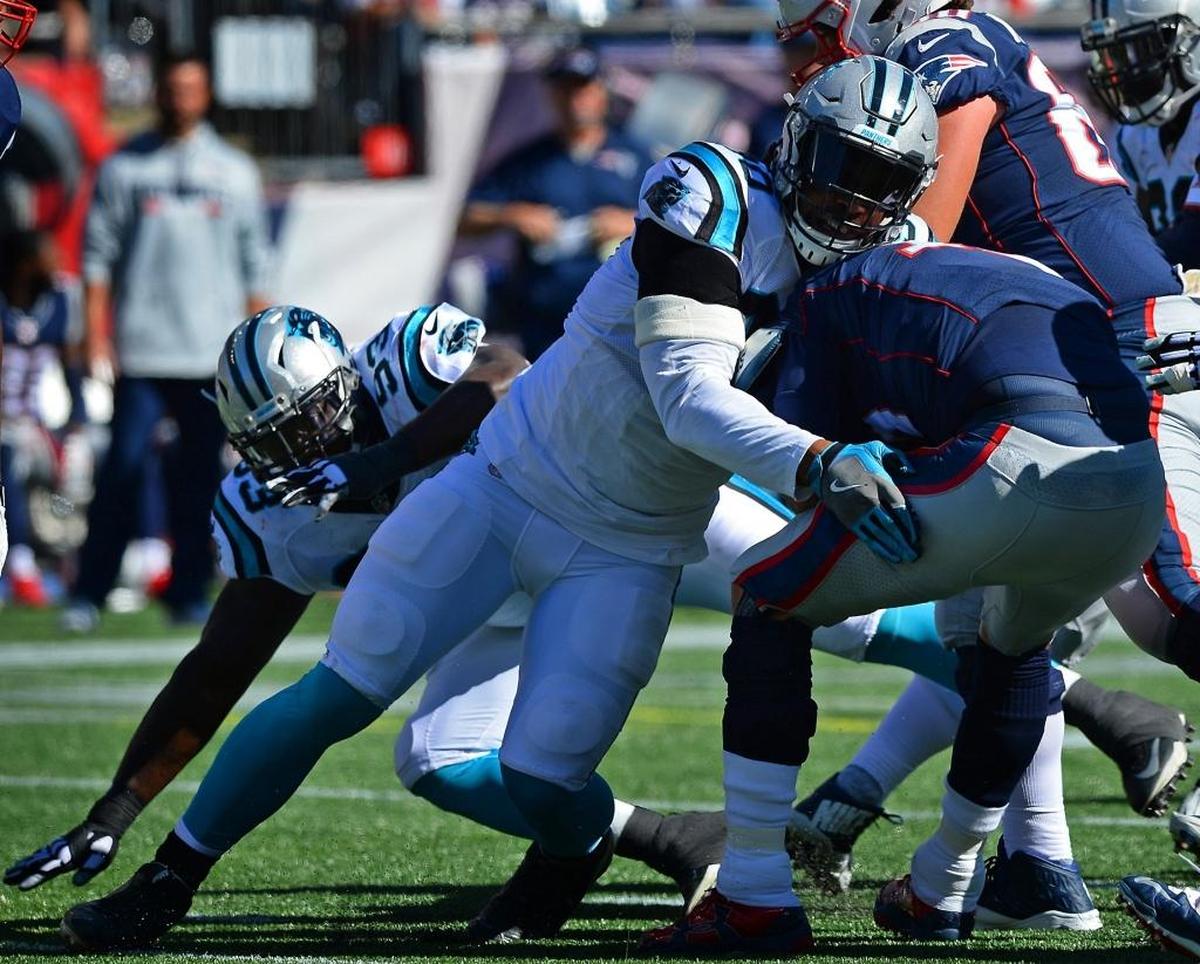 Carolina Panthers defensive end Julius Peppers, left, had two sacks of New England Patriots quarterback Tom Brady on Sunday as the Panthers won 33-30.