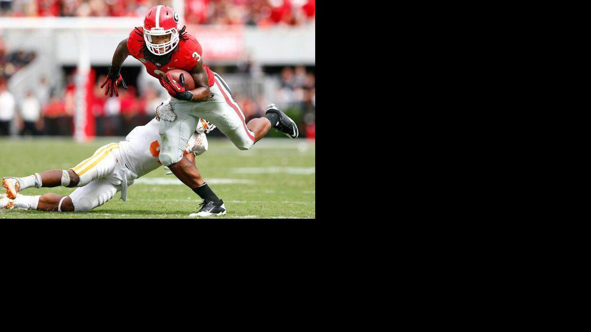 
Georgia running back Todd Gurley breaks a tackle against Tennessee at Sanford Stadium on Sept. 27, 2014 in Athens, Ga. 
