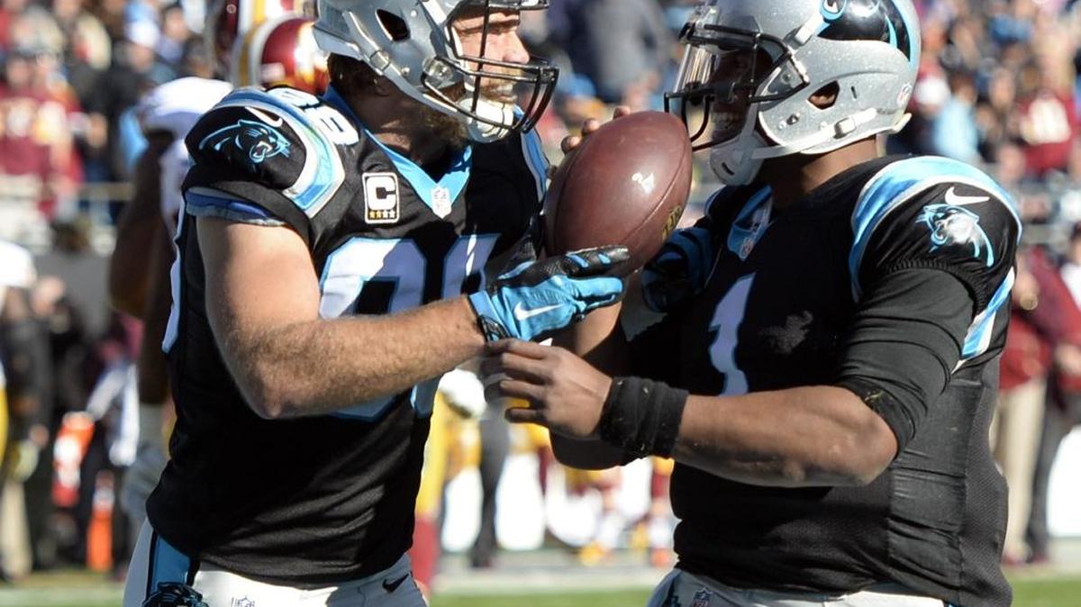 Carolina Panthers' Greg Olsen (88) gives the ball to Cam Newton (1) after connecting on a touchdown against Washington in the second quarter at Bank of America Stadium on Sunday, November 22, 2015.