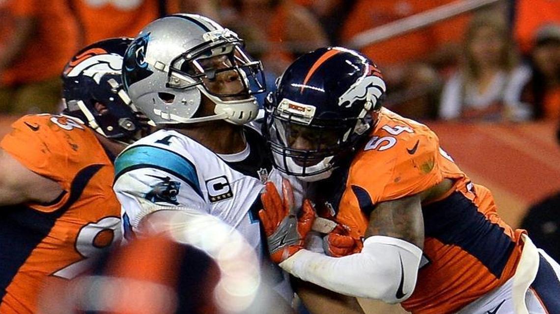 Carolina Panthers quarterback Cam Newton takes a helmet-to-helmet hit from Denver Broncos linebacker Brandon Marshall during the third quarter on Thursday at Sports Authority Field at Mile High in Denver. Newton took several hits to the helmet in the 21-20 loss.