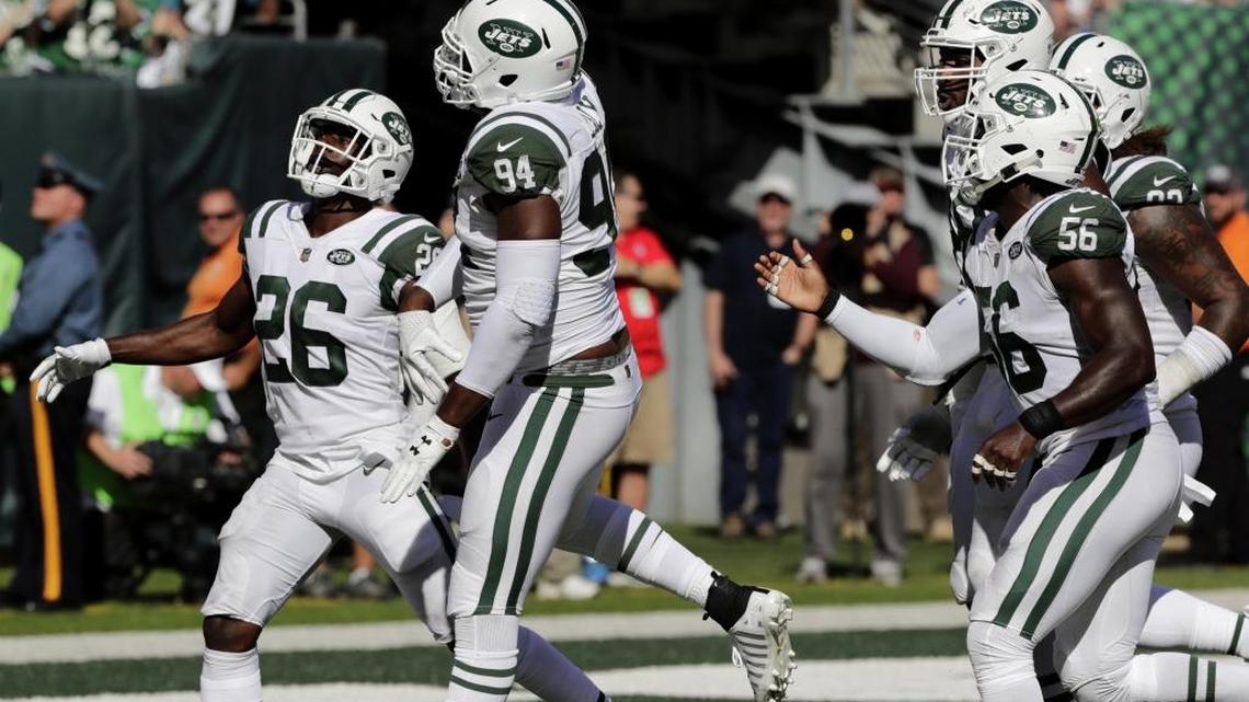 New York Jets lineman Kony Ealy (second from left) celebrates his interception with Marcus Maye, left, and others during the second half of an NFL game in October against Jacksonville in East Rutherford, N.J.