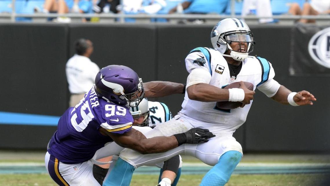 Carolina Panthers quarterback Cam Newton, right, is brought down by Minnesota Vikings defensive end Danielle Hunter on Sunday at Bank of America Stadium. The Vikings won 22-10.