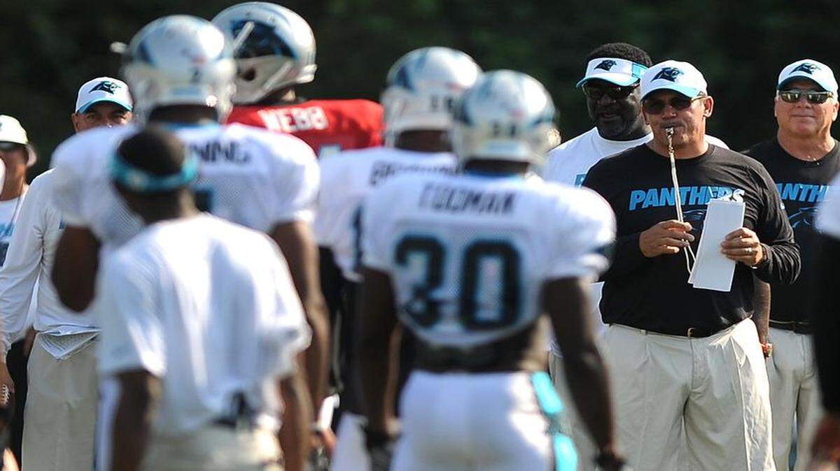 
Carolina Panthers head coach Ron Rivera, right, calls the team together during practice on Monday.
