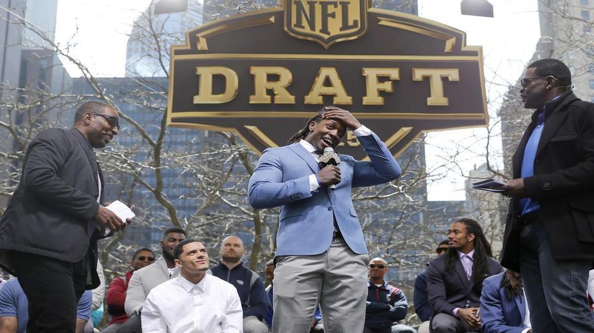 
Cris Carter, left, and Michael Irvin, right, interview Wisconsin running back Melvin Gordon during introductions at a pre-draft rally of 2015 NFL Draft prospects, and various league legends at Pioneer Court on Wednesday.
