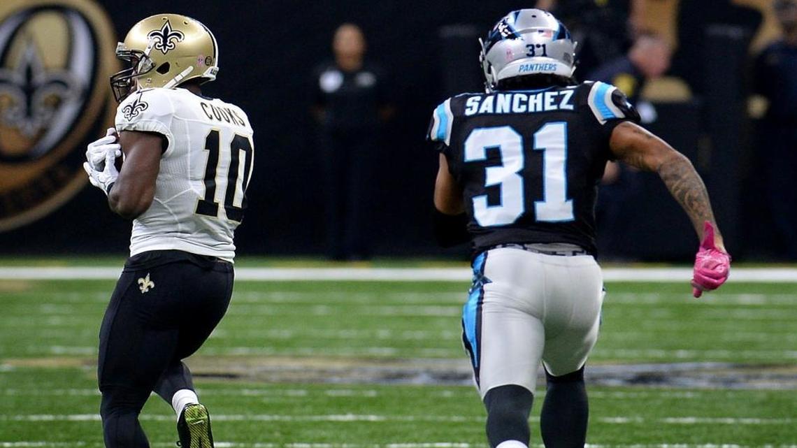 New Orleans Saints wide receiver Brandin Cooks (10) catches a touchdown pass from quarterback Drew Brees as Carolina Panthers rookie cornerback Zack Sanchez gives chase during the first quarter Sunday. Brees carved up the Panthers during the Saints’ 41-38 victory.