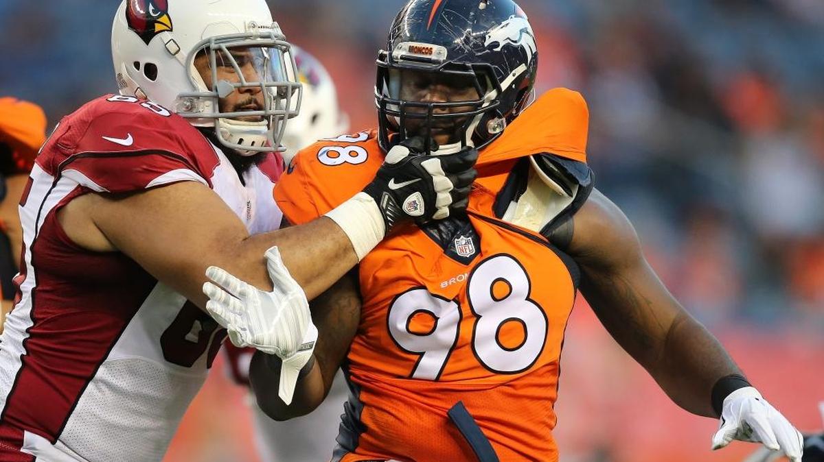 Darius Kilgo #98 of the Denver Broncos battles on the line of scrimmage against the block of Jon Halapio #65 of the Arizona Cardinals during preseason action at Sports Authority Field at Mile High on September 3, 2015 in Denver, Colorado.